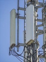 Telecommunication tower stands tall against a clear blue sky, broadcasting signals for mobile