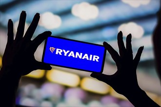 In this photo illustration, the Ryanair logo is displayed on a smartphone screen