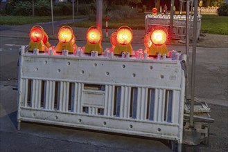 Roadworks with barriers and warning lights at night