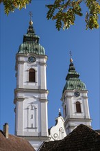 The two towers of the former collegiate church of St Peter, a Roman Catholic parish church, Bad