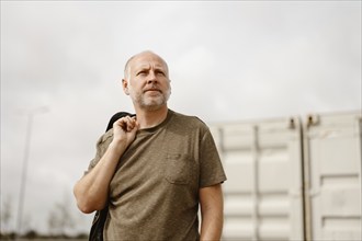 Caucasian Man posing in front of industrial background in Albufeira, Algarve, Portugal, Europe