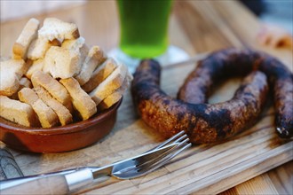 Typical Portuguese Appetizer with toasts and green beverage in the background in Albufeira,