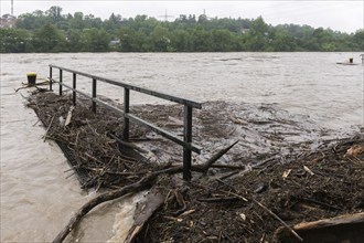 Symbolic image extreme weather, global warming, climate change, flood, washed up wood, footbridge,