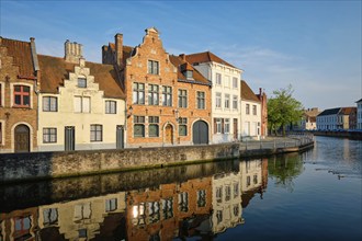 Typical Belgian cityscape Europe tourism concept, canal and old houses on sunset. Bruges (Brugge),