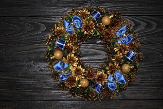 Christmas wreath on dark wooden background