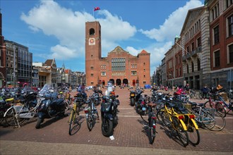 Amsterdam, Netherlands, May 7, 2017: Beursplein with parked bicycles motorcycles and Beurs van