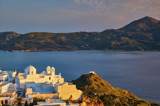 View of Plaka village on Milos island with traditional greek white houses with Greek Orthodox