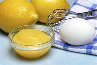 Lemon cream, glass bowl and ingredients, lemons, egg, jam, lemon spread, whisk