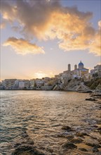 View of the village with the Greek Orthodox church of Agios Nikolaos, Asteria Beach, at sunset with