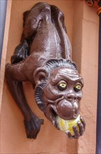 Sculpture of a monkey biting into a sour apple, so-called monkey fountain, historic old town