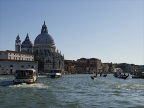 Boats and gondolas on the Grand Canal, with the church of Santa Maria della Salute in the