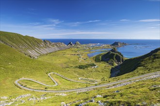 Coast and mountains, view of the village of Sørland on the island of Værøy, Vaeroy, Lofoten,