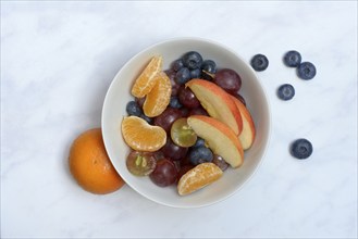 Various pieces of fruit in bowl, fruit salad