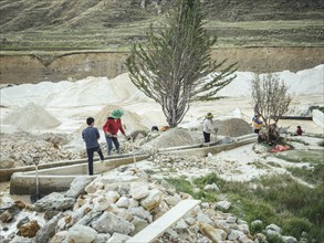 A young man and three woman work in a kaolin mine, Pachacayo, Peru, South America