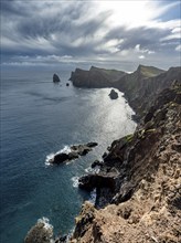 Red cliffs and rocks in the sea, coastal landscape with dramatic sky, Ponta de São Lourenço,