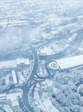 A snow-covered city dominated by winter fog photographed from the air, Black Forest, Calw, Germany,