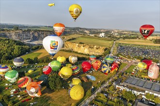 Colourful hot-air balloons at mass launch, crowd on fairground, hot-air balloon festival, 26th