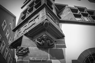 Southeast corner with bay window and supporting sculpture of a bare-breasted mermaid at the New