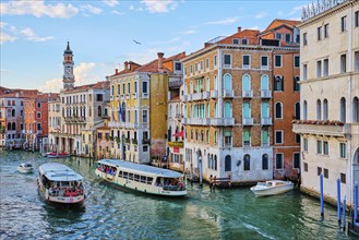 VENICE, ITALY, JUNE 27, 2018: Grand Canal with boats, vaporetto and gondolas on sunset from Rialto