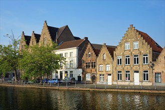 Typical Belgian cityscape Europe tourism concept, canal and old houses on sunset. Bruges (Brugge),