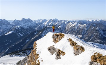 Ski tourers at the summit of Schafreuter, view of snowy mountain panorama, Karwendel, Tyrol,