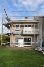 Terraced house from the sixties with scaffolding, North Rhine-Westphalia, Germany, Europe