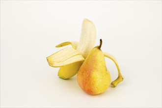 Half peeled banana with pear, studio shot, white background, healthy food