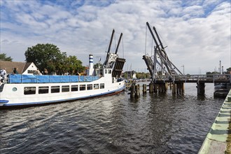 Excursion boat passing through open drawbridge, double balance beam bridge, Wiecker wooden bascule