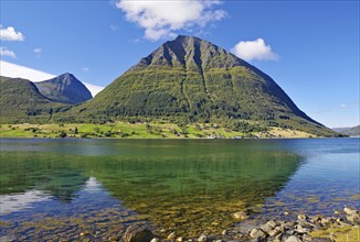 Steep mountains reflected in the water of a fjord, Aldersund, FV 17, Kystriksveien, Nordland,