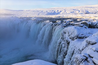 Godafoss waterfall in first morning sun, snow-covered landscape, Northern Iceland Eyestra, Iceland,