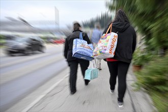 Wiping Picture Women with Migros and Coop Shopping Bag, Switzerland, Europe