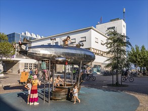 Children on a playground with a play zeppelin in front of the Zeppelin Museum, Friedrichshafen,