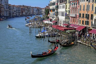 Venetian gondola at the Rialto Bridge on the Grand Canal, San Marco district, Venice, Veneto