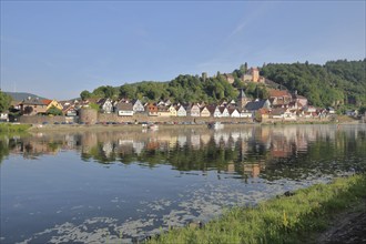 View of townscape with castle, churches and town fortification of Hirschhorn with reflection in