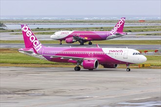 Airbus A320 Peach aircraft with registration JA204P at Okinawa Airport (OKA) in Naha, Japan, Asia