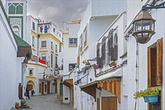 White houses and closed shops in shopping street on Friday in medina of the city Tangier, Tanger,