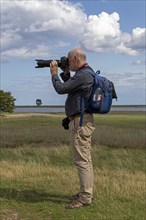 Photographer taking pictures, coast near Maasholm, Schleswig-Holstein, Germany, Europe