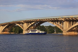 Bridge over the Dnieper River and a pleasure boat, Kiev, Ukraine, Europe