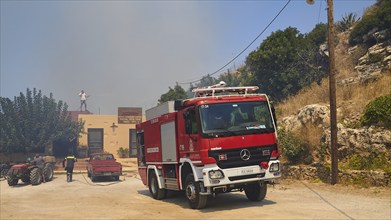 Taverna, threatened by fire, firefighting, fire engine, smoke, fire, Falassarna, west coast, Crete,