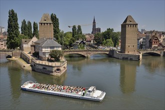 Excursion boat on the River Ill at the Ponts Couverts bridge with towers, UNESCO World Heritage