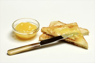 Lemon cream, in glass bowl, on toast, jam, lemon spread, edible knife