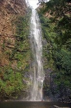 Black family having fun bathing under the Wli waterfall, Wli Falls in Ghana, West Africa