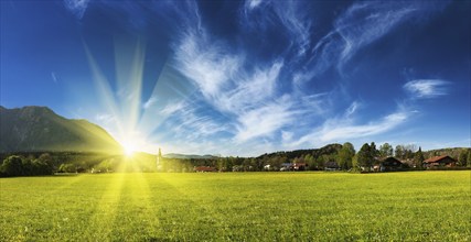 Panorama of German countryside and village on sunset with sun. Bavaria, Germany, Europe