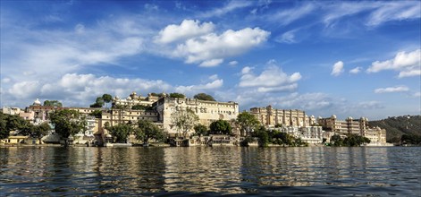 India luxury tourism concept background, panorama of Udaipur City Palace from Lake Pichola.