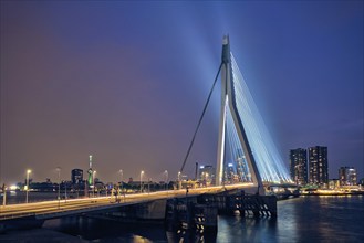 Erasmus Bridge (Erasmusbrug) and Rotterdam skyline illuminated at night. Rotterdam, Netherlands