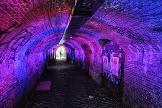 UTRECHT, NETHERLANDS, MAY 25, 2018: Illuminated Ganzemarkt tunnel to Oudegracht in the old city