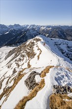 Ski tourers at the summit of Schafreuter, view of snow-covered mountain panorama, Karwendel, Tyrol,