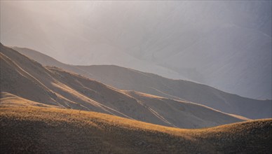 Mountain landscape detail in the evening light, Hills overgrown with yellow grass, Toktogul