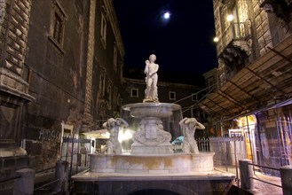 Illuminated fountain, small full moon, night shot, baroque old town, Catania, east coast, Sicily,