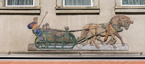 Historical relief on a house facade, people in a horse-drawn sleigh, Emmendingen,